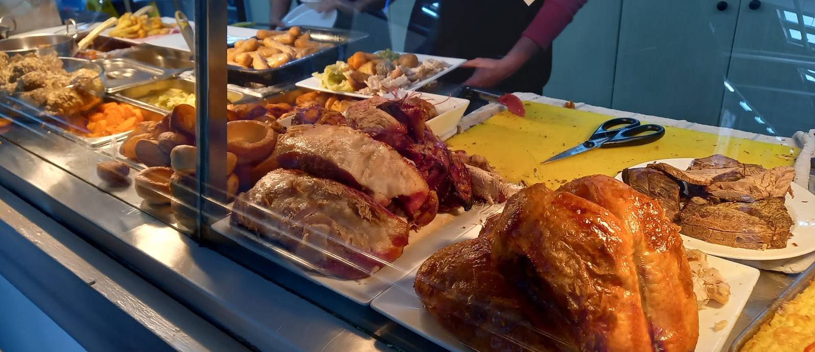 Fresh turkey, gammon and beef carved at the Corner Café roast counter, with roast potatoes, Yorkshire puddings and stuffing laid out ready